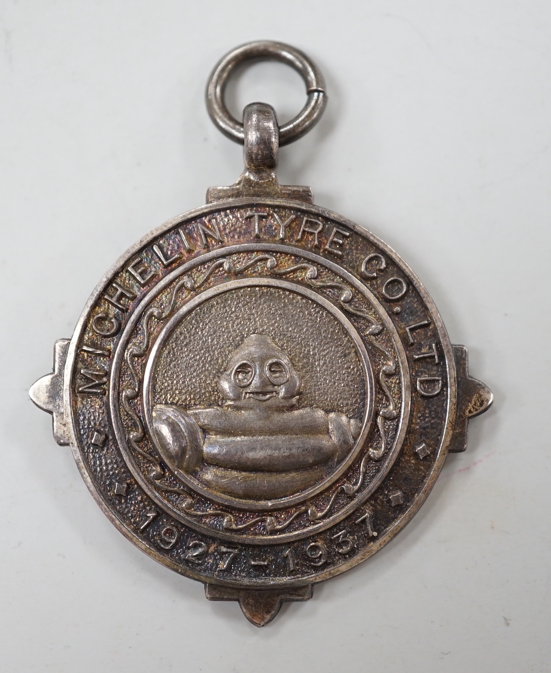 A rare Michelin Tyre silver medallion